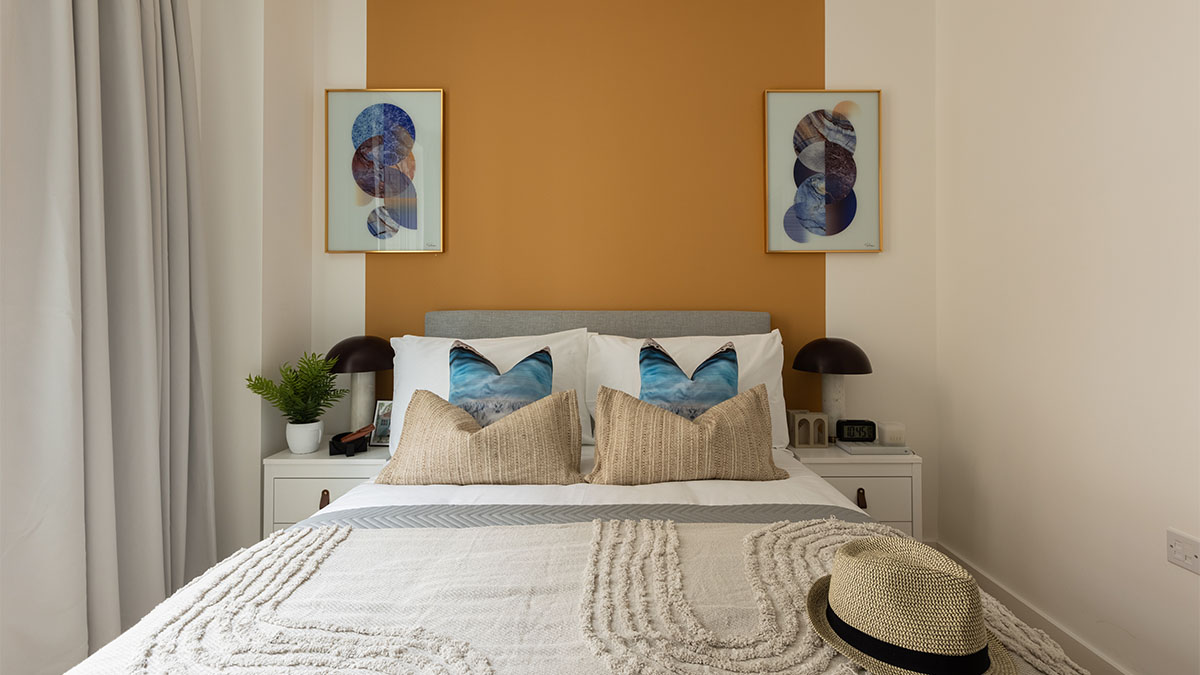 stylish-bedroom-with-a-mustard-yellow-accent-wall-and-a-cozy-bed-of-Verdica-show-flats