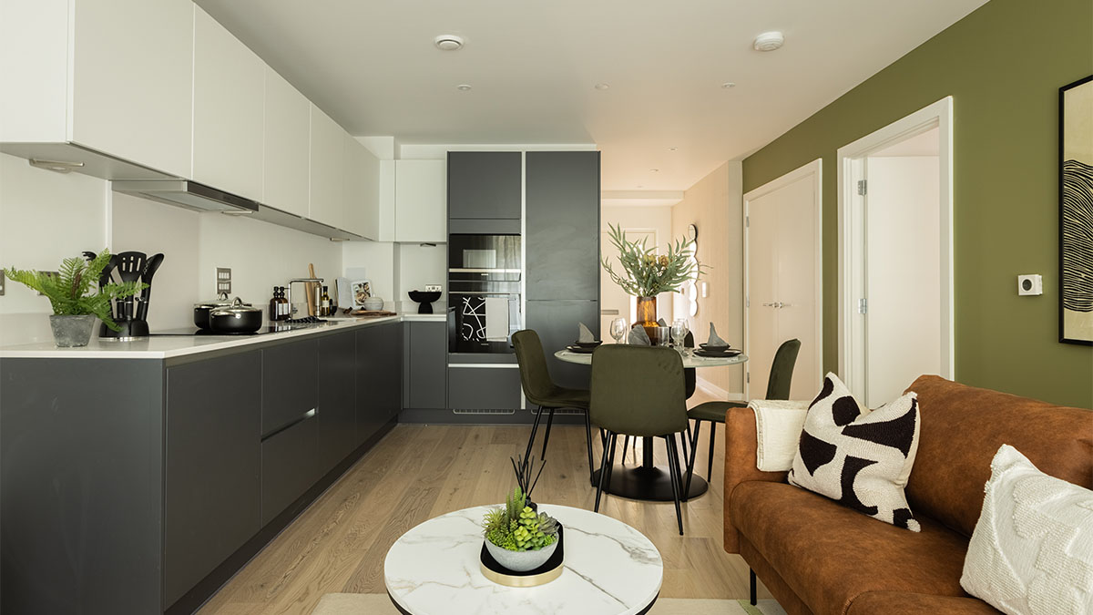 open-plan-kitchen-and-living-room-with-a-dining-table-and-sofa-of-Verdica-show-flats